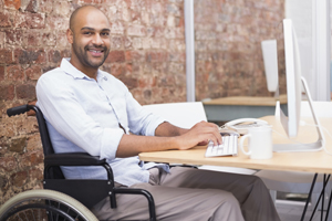 smiling-businessman-in-wheelchair-working-at-his-desk-gm516651699-48388598-300x200.jpg
